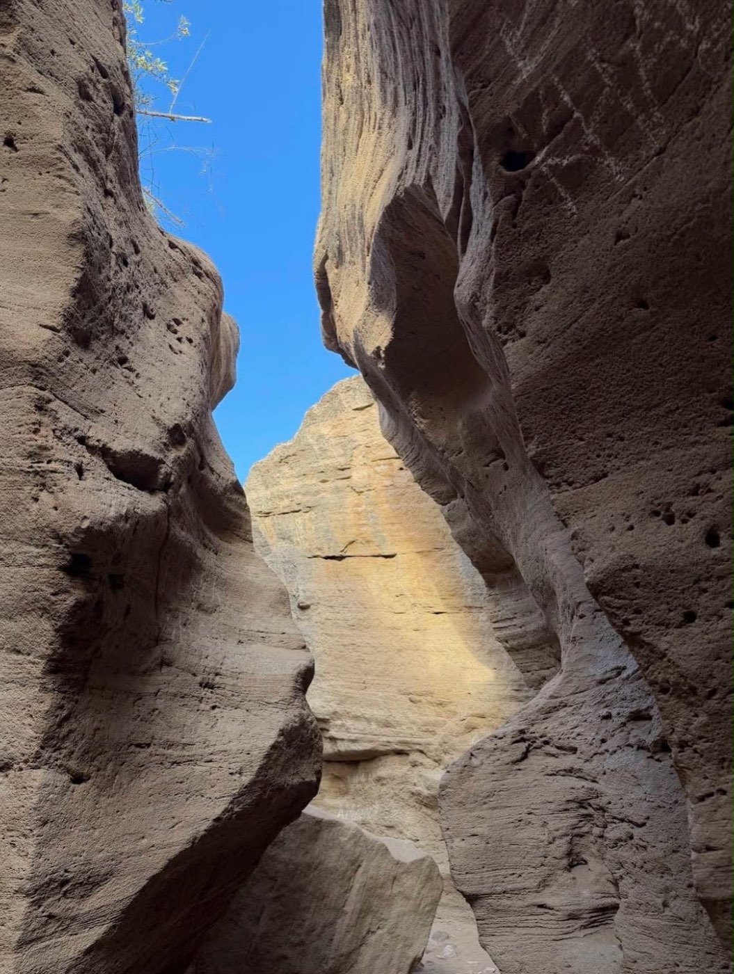 Narrow rock canyon under a blue sky